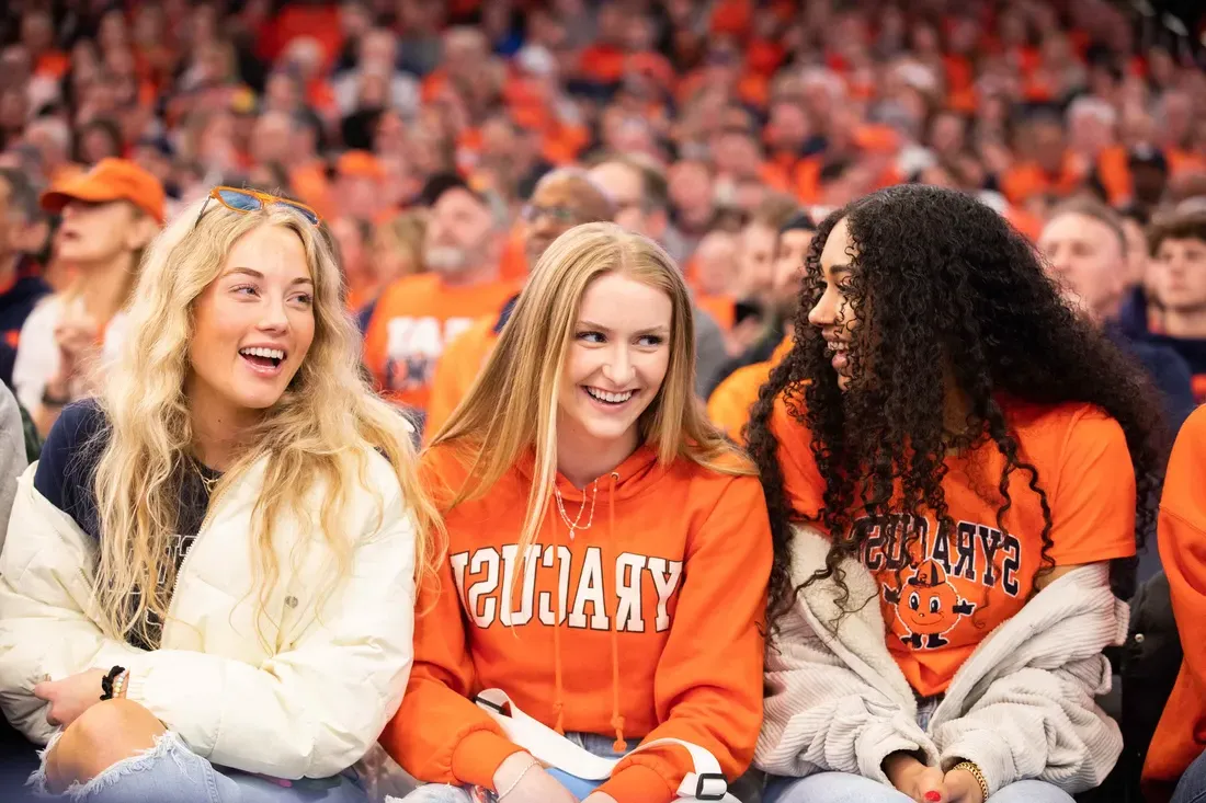 Students smiling at a game.